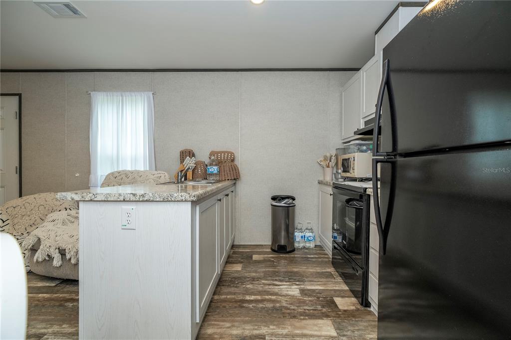 36720 Emeralda Island Road Leesburg, FL 34788 - Photo 17 of 43 a kitchen with a refrigerator and a sink