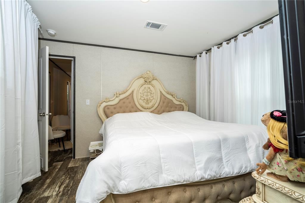 36720 Emeralda Island Road Leesburg, FL 34788 - Photo 20 of 43 a bedroom with a bed and a dresser