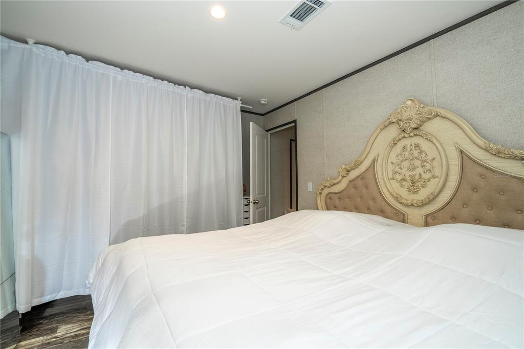 36720 Emeralda Island Road Leesburg, FL 34788 - Photo 23 of 43 a bedroom with a bed and a window