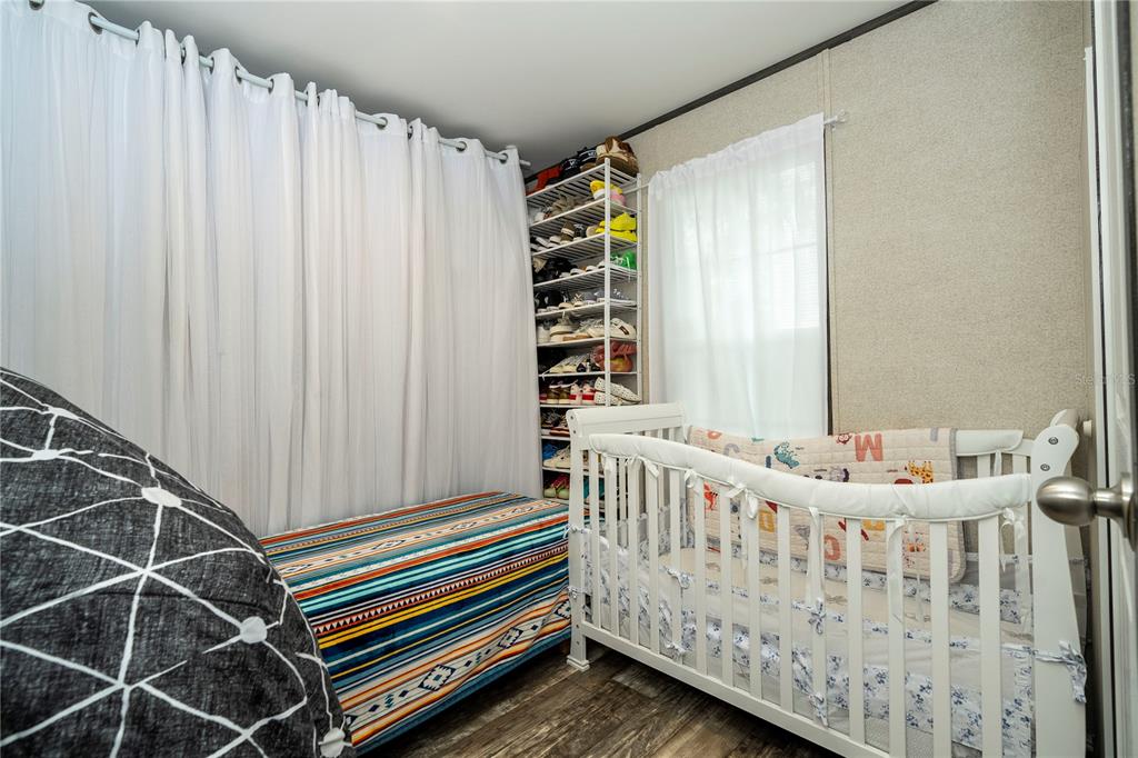 36720 Emeralda Island Road Leesburg, FL 34788 - Photo 29 of 43 a bedroom with furniture and a window