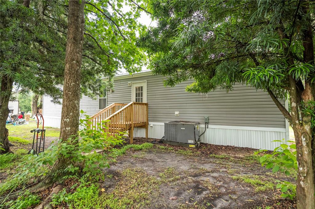 36720 Emeralda Island Road Leesburg, FL 34788 - Photo 38 of 43 a view of a house with backyard and a tree