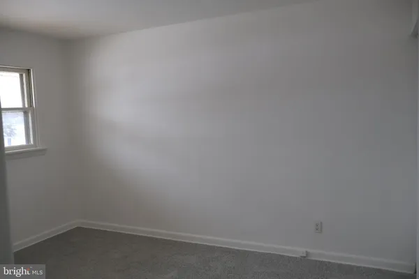 a view of an empty room and a window