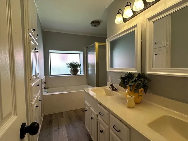 a bathroom with a tub sink and mirror