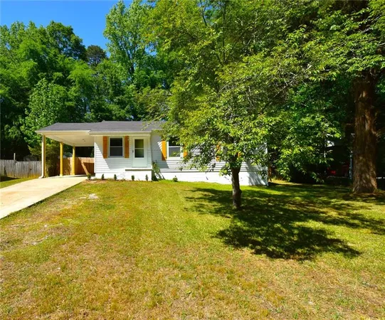 a view of a house with swimming pool and a yard