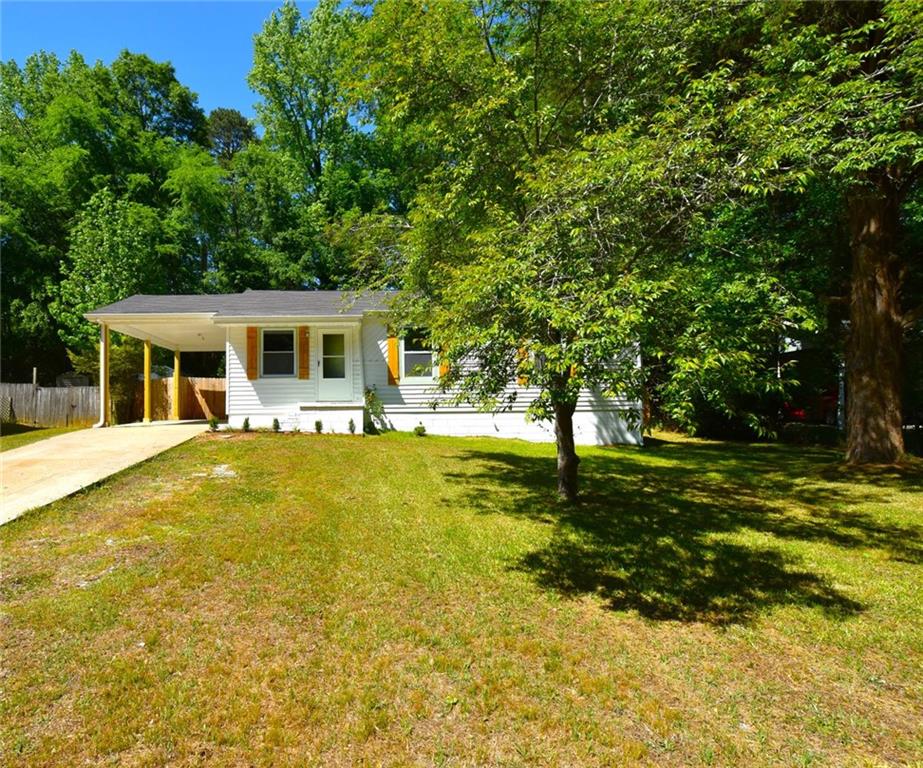 a view of a house with swimming pool and a yard