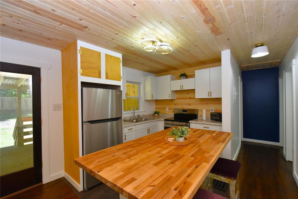 2030 Sanders Drive Austell, GA 30168 - Photo 2 of 42 a kitchen with a refrigerator and a table