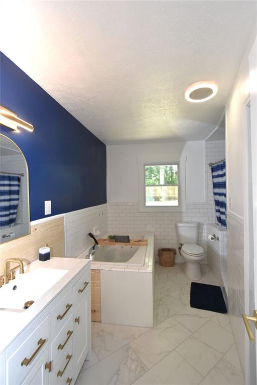 2030 Sanders Drive Austell, GA 30168 - Photo 23 of 42 a bathroom with a sink a toilet and a bathtub