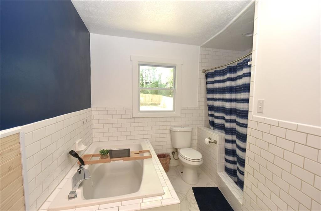 2030 Sanders Drive Austell, GA 30168 - Photo 25 of 42 a bathroom with a sink a toilet and shower