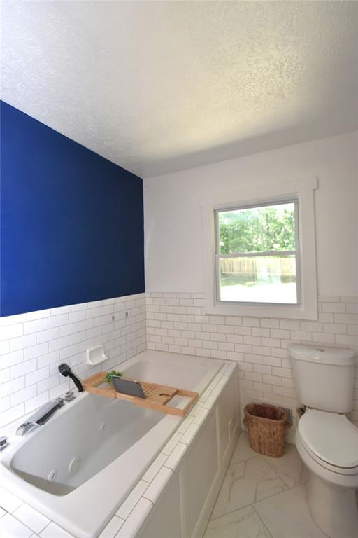 2030 Sanders Drive Austell, GA 30168 - Photo 26 of 42 a bathroom with a granite countertop sink and a bathtub