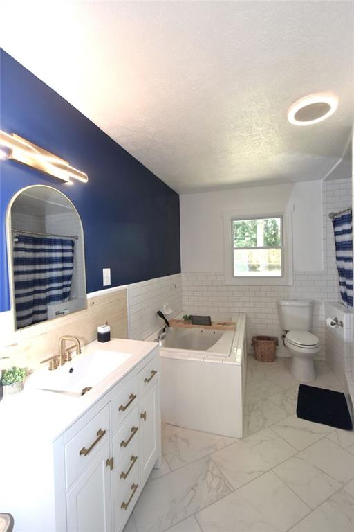 2030 Sanders Drive Austell, GA 30168 - Photo 27 of 42 a bathroom with a double vanity sink a mirror and bathtub