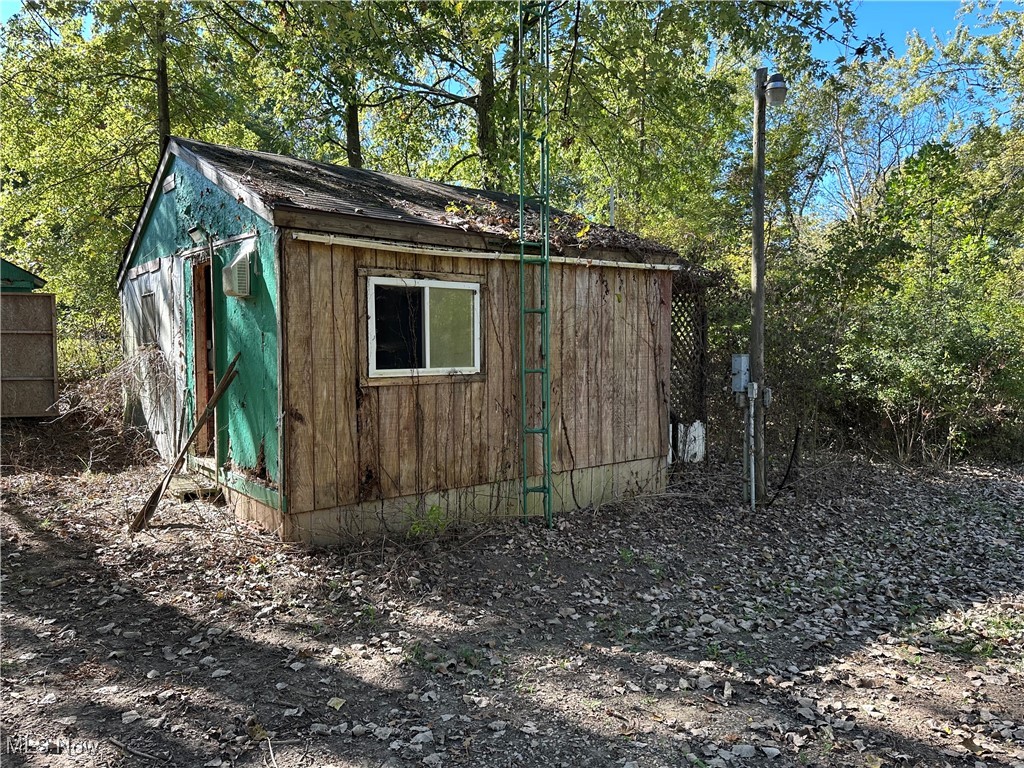 7320 Fenner Road Shelby, OH 44875 - Photo 20 of 21 View of 0ld tiny home structure featuring view of scattered trees