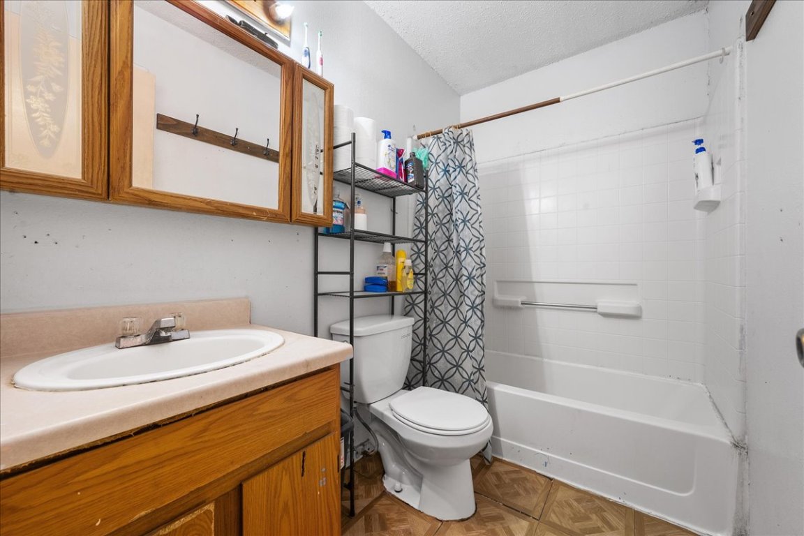1107 Sturgis Street Taylor, TX 76574 - Photo 13 of 22 a bathroom with a sink a toilet and shower