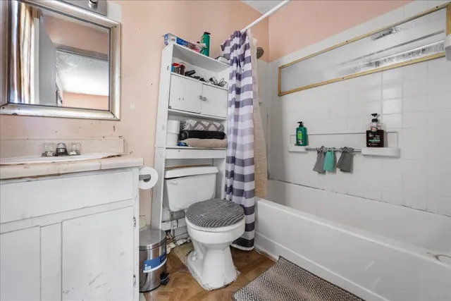 a bathroom with a sink toilet vanity and bathtub