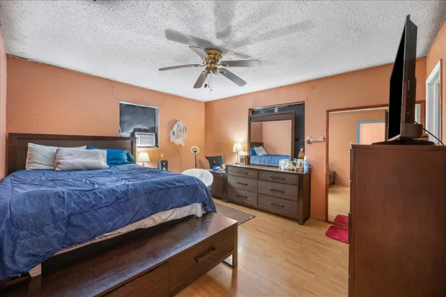 a bedroom with a bed dresser and a large mirror