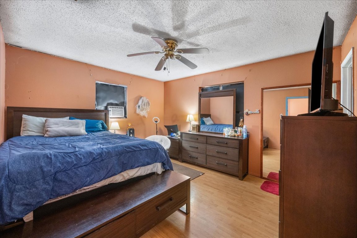 1107 Sturgis Street Taylor, TX 76574 - Photo 17 of 22 a bedroom with a bed dresser and a large mirror