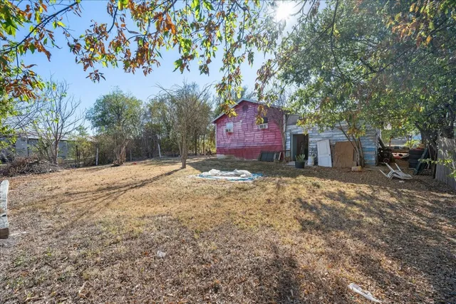 a large tree in front of a house