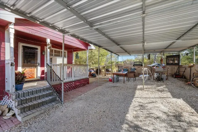 a view of a patio with table and chairs under an umbrella