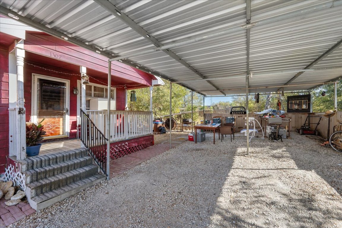 1107 Sturgis Street Taylor, TX 76574 - Photo 3 of 22 a view of a patio with table and chairs under an umbrella
