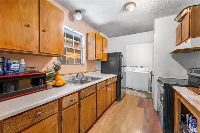 a kitchen with a sink a stove and cabinets