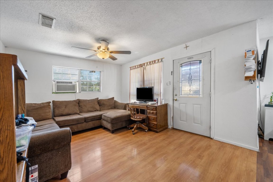 1107 Sturgis Street Taylor, TX 76574 - Photo 8 of 22 a living room with furniture a ceiling fan and a window