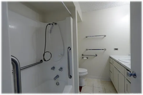 a bathroom with a granite countertop sink mirror and vanity