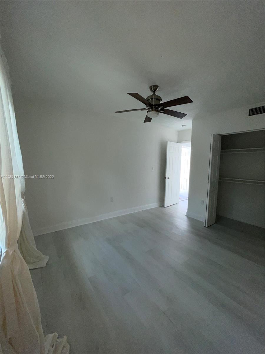 560 Northeast 63rd Street, Unit 3 Miami, FL 33138 - Photo 12 of 16 a view of a room with a empty space and a ceiling fan