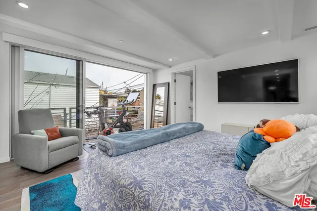 a bedroom with furniture and a flat screen tv