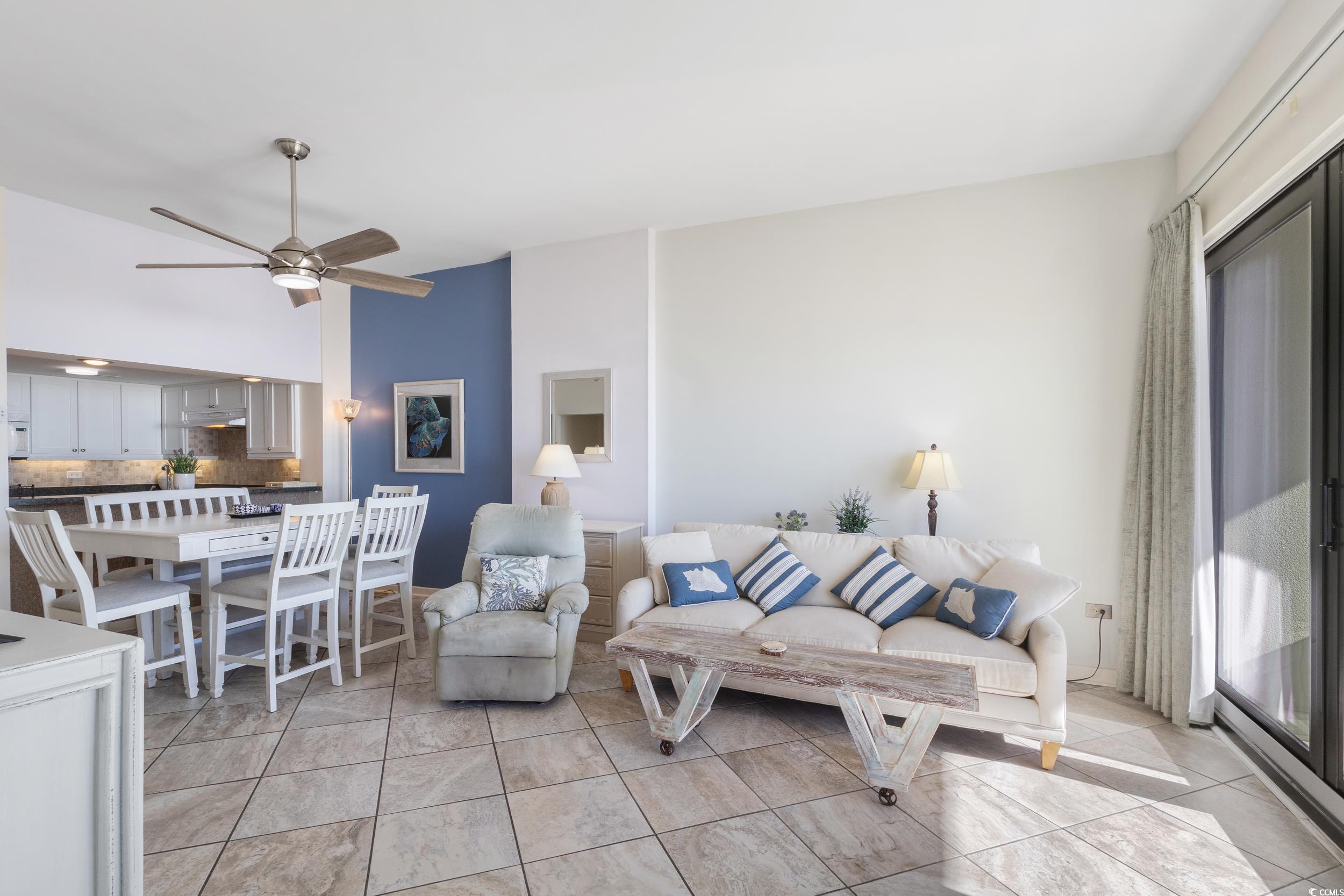 100 Ocean Creek Drive, Unit G14 Myrtle Beach, SC 29572 - Photo 15 of 40 Living area featuring ceiling fan, light tile patterned floors, and a high ceiling