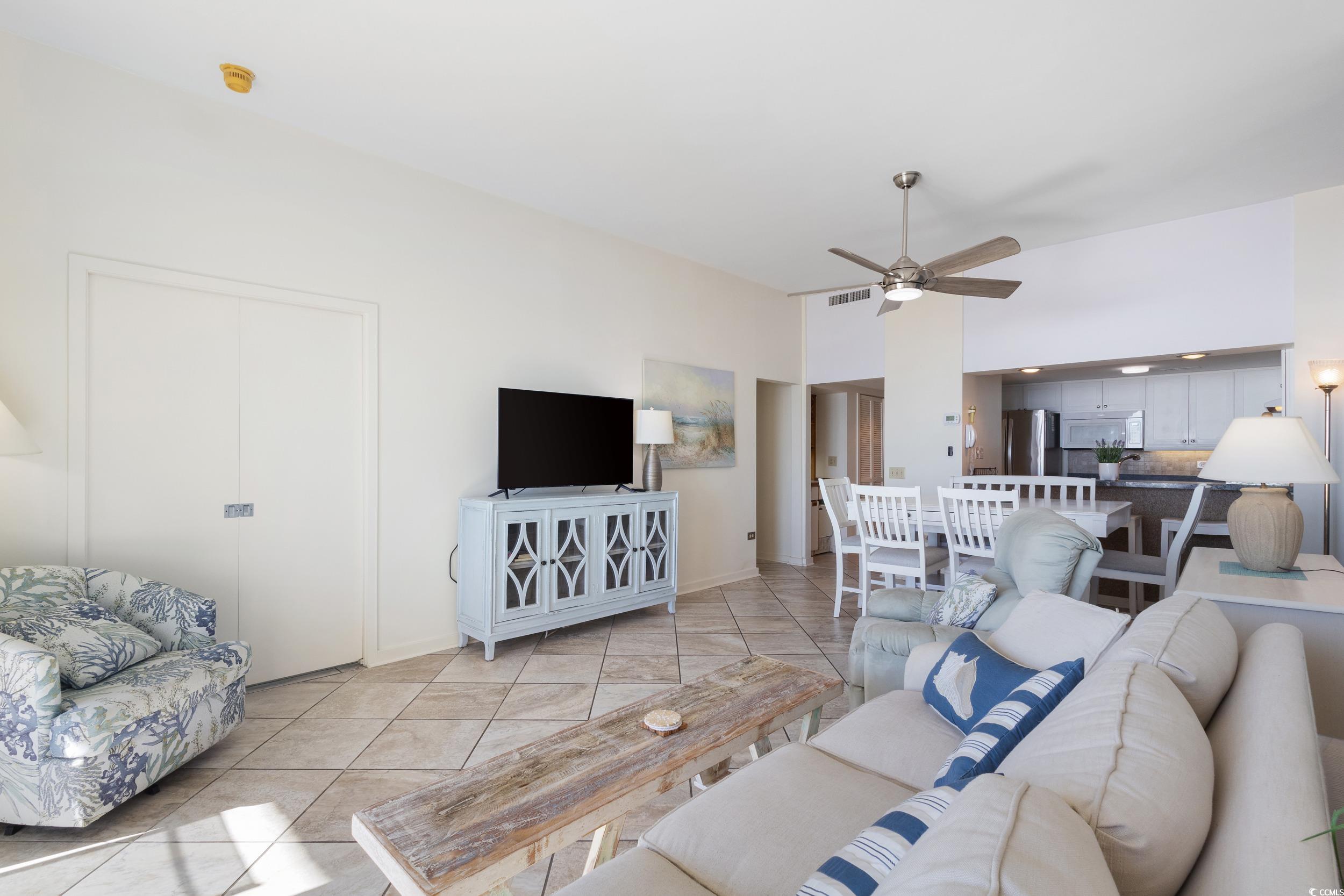 100 Ocean Creek Drive, Unit G14 Myrtle Beach, SC 29572 - Photo 16 of 40 Living area with tile patterned floors and a ceiling fan