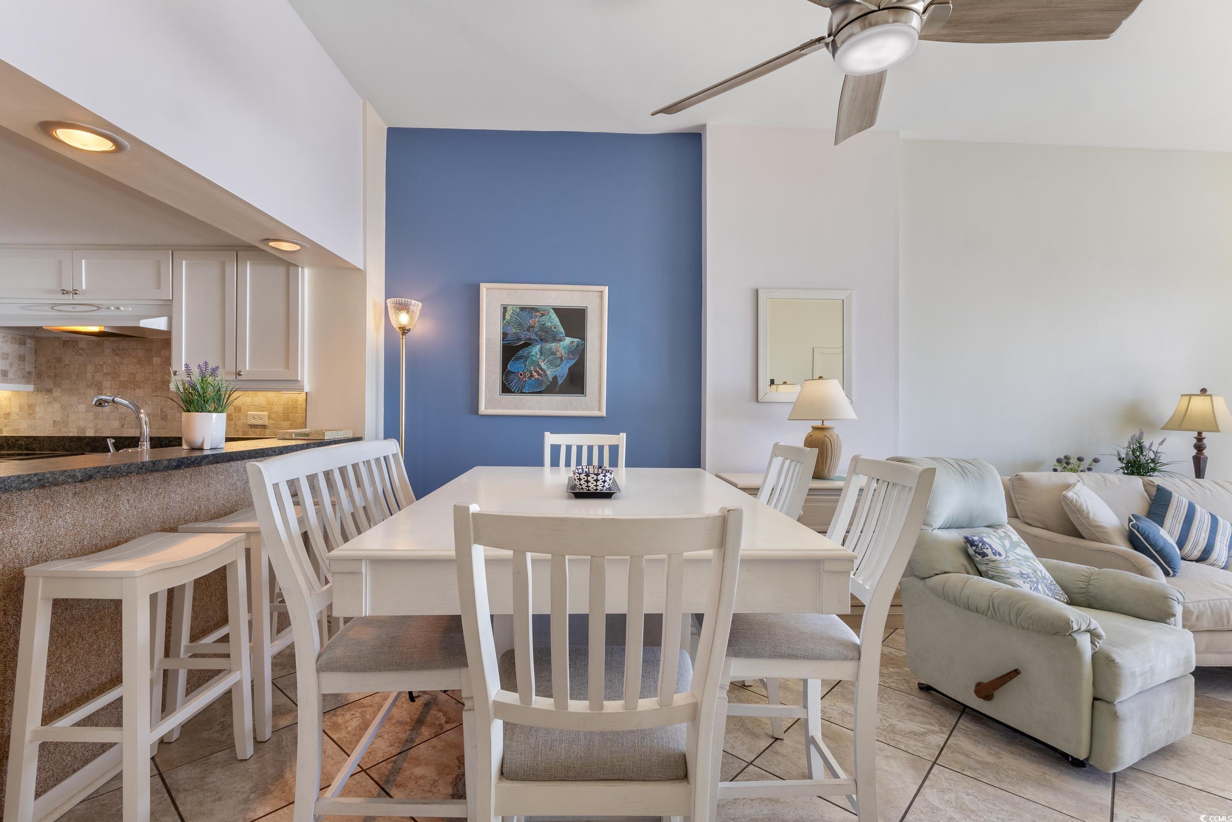 100 Ocean Creek Drive, Unit G14 Myrtle Beach, SC 29572 - Photo 17 of 40 Dining room with ceiling fan and light tile patterned floors