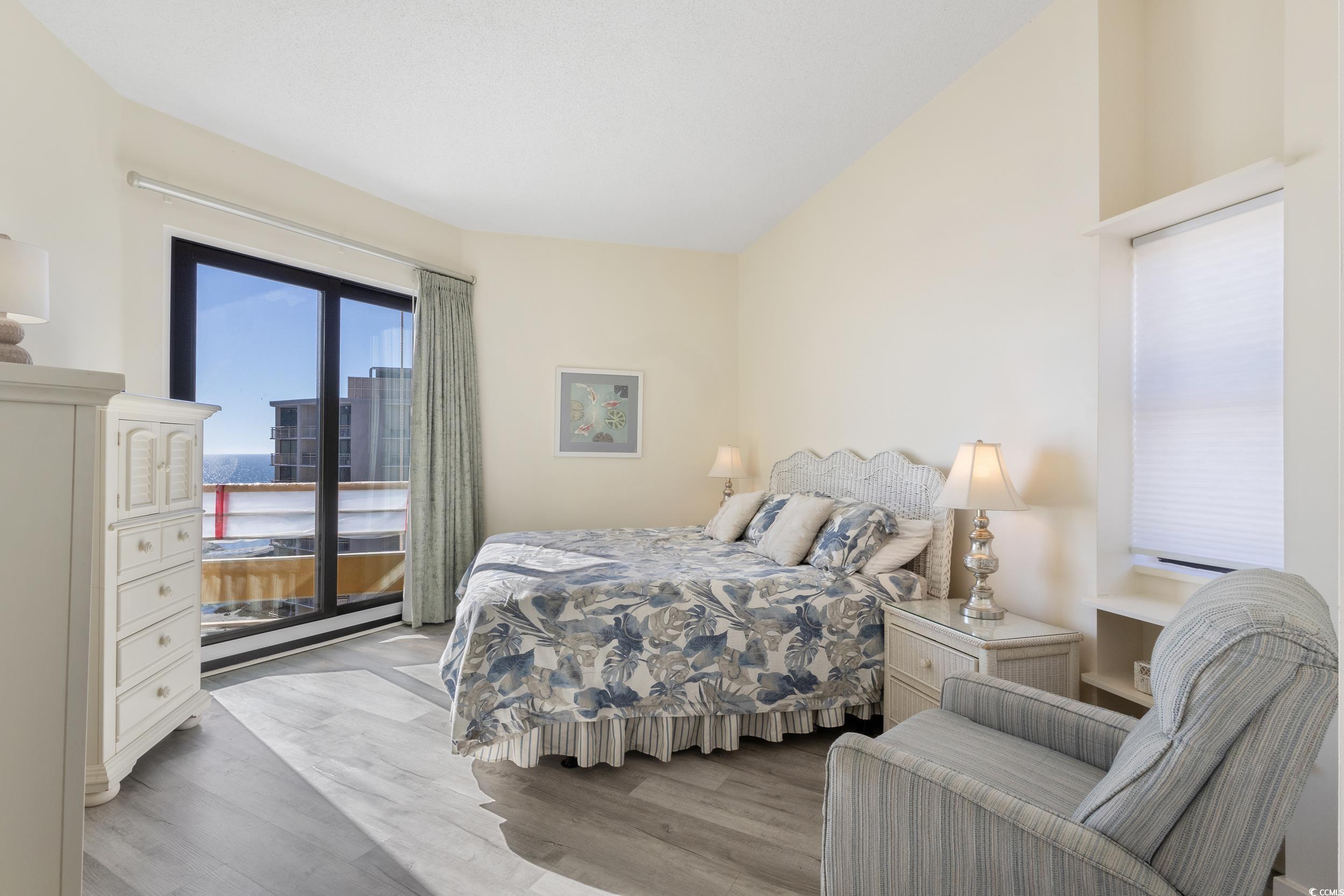 100 Ocean Creek Drive, Unit G14 Myrtle Beach, SC 29572 - Photo 21 of 40 Bedroom with access to exterior and light wood-style floors