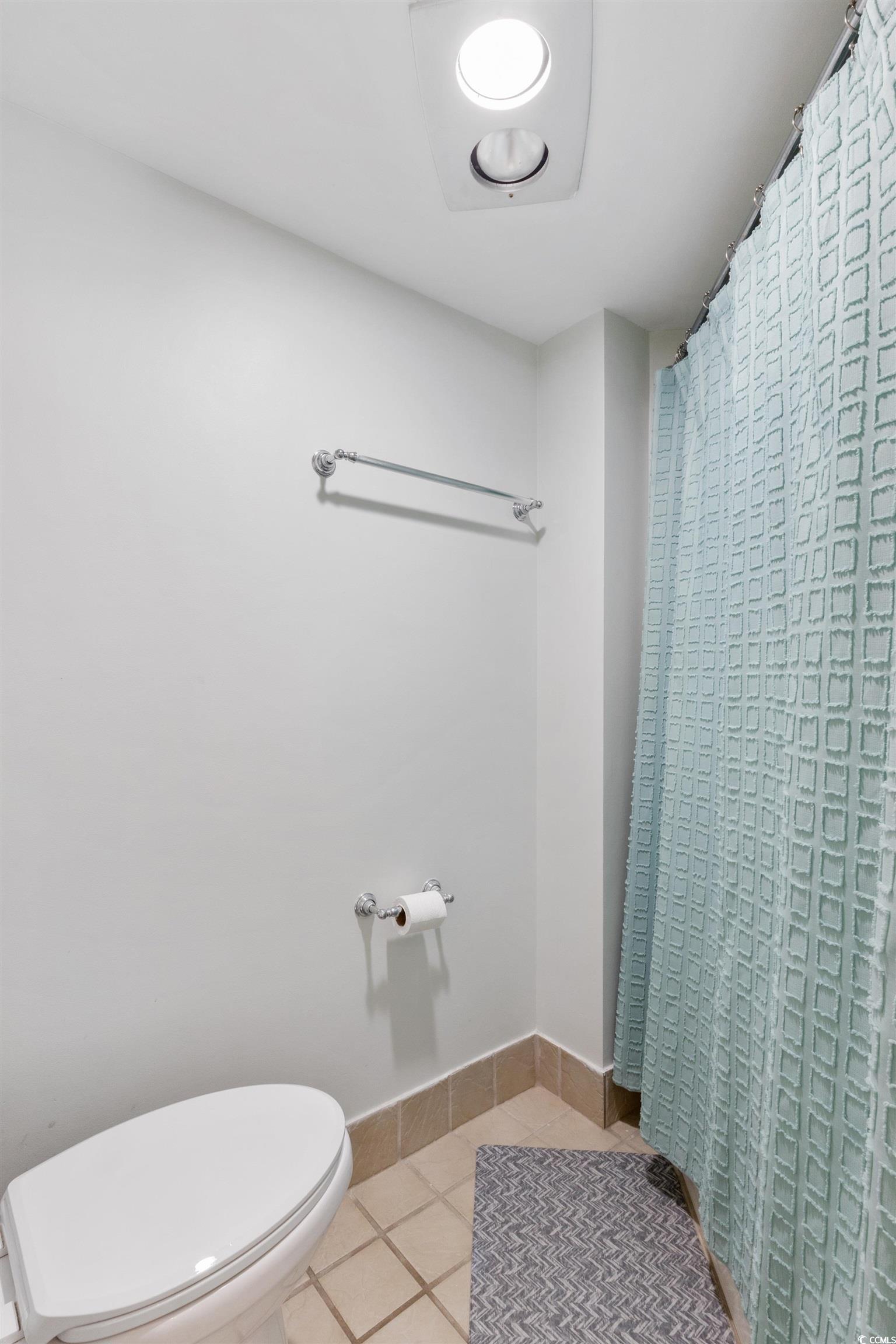 100 Ocean Creek Drive, Unit G14 Myrtle Beach, SC 29572 - Photo 23 of 40 Full bathroom featuring a shower with curtain and light tile patterned floors