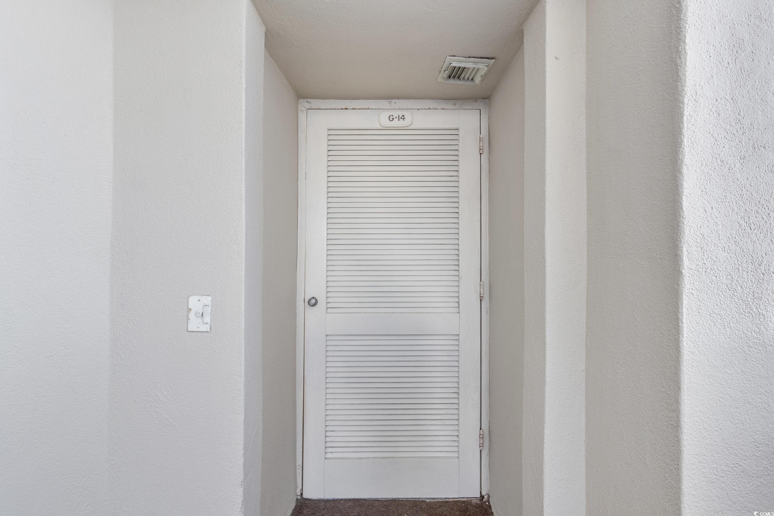 100 Ocean Creek Drive, Unit G14 Myrtle Beach, SC 29572 - Photo 3 of 40 Detailed view of carpet floors and a textured wall