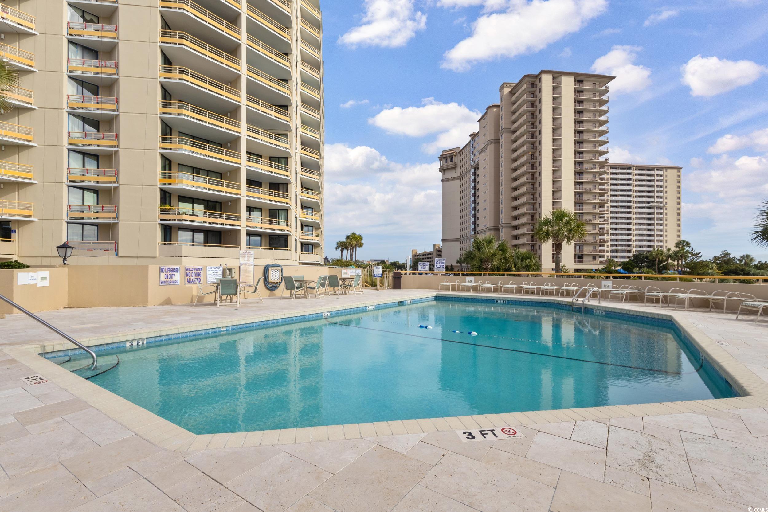 100 Ocean Creek Drive, Unit G14 Myrtle Beach, SC 29572 - Photo 31 of 40 Community pool featuring a patio area