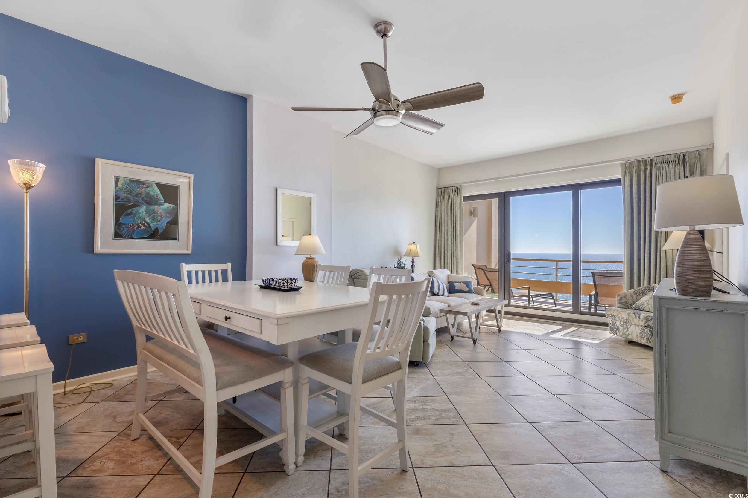 100 Ocean Creek Drive, Unit G14 Myrtle Beach, SC 29572 - Photo 6 of 40 Dining area featuring a water view, a ceiling fan, and light tile patterned floors