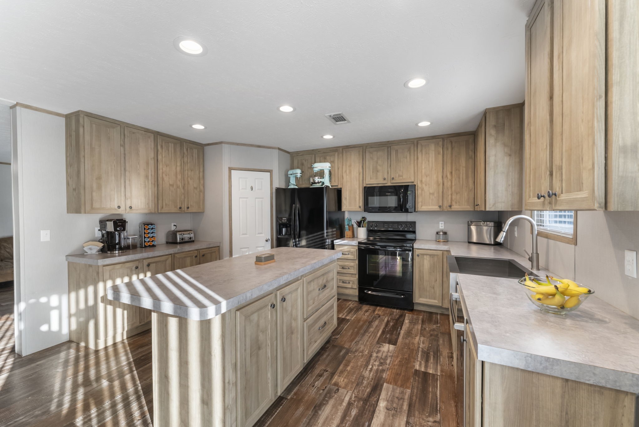 6913 Fm 3081 Road Willis, TX 77378 - Photo 11 of 46 a kitchen with stainless steel appliances wooden cabinets sink and refrigerator
