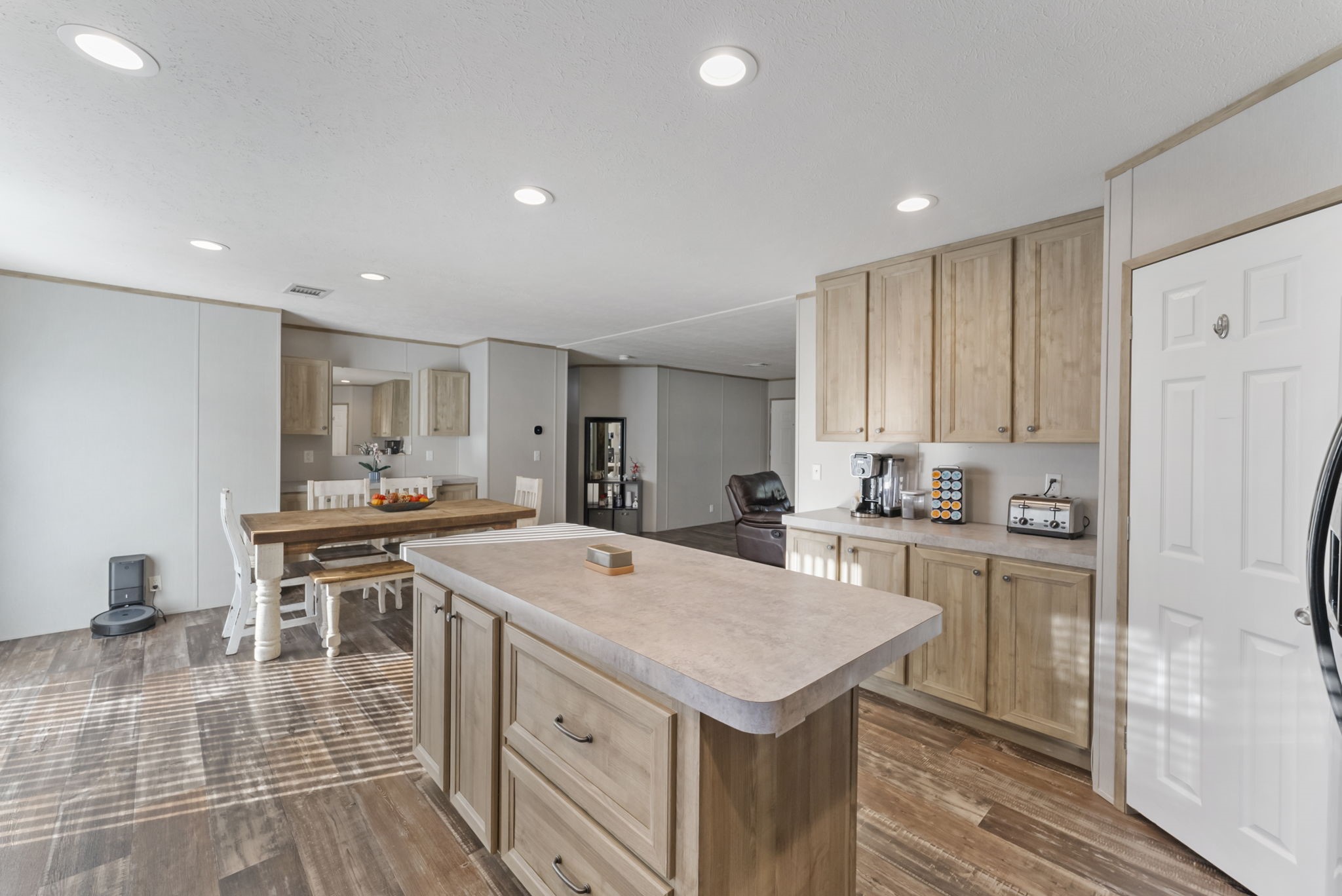 6913 Fm 3081 Road Willis, TX 77378 - Photo 14 of 46 a kitchen with a stove a refrigerator a sink dishwasher with a dining table and chairs with wooden floor