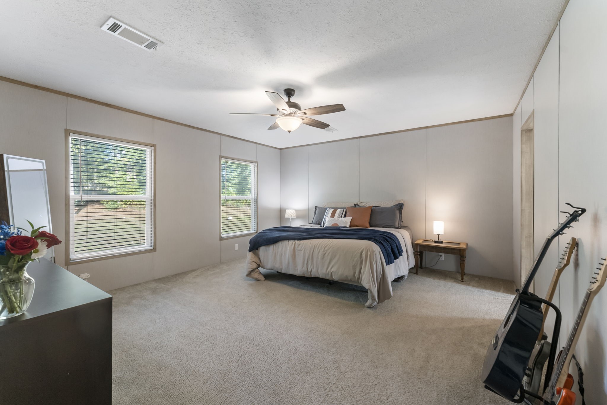 6913 Fm 3081 Road Willis, TX 77378 - Photo 15 of 46 a bedroom with a large bed and a chandelier
