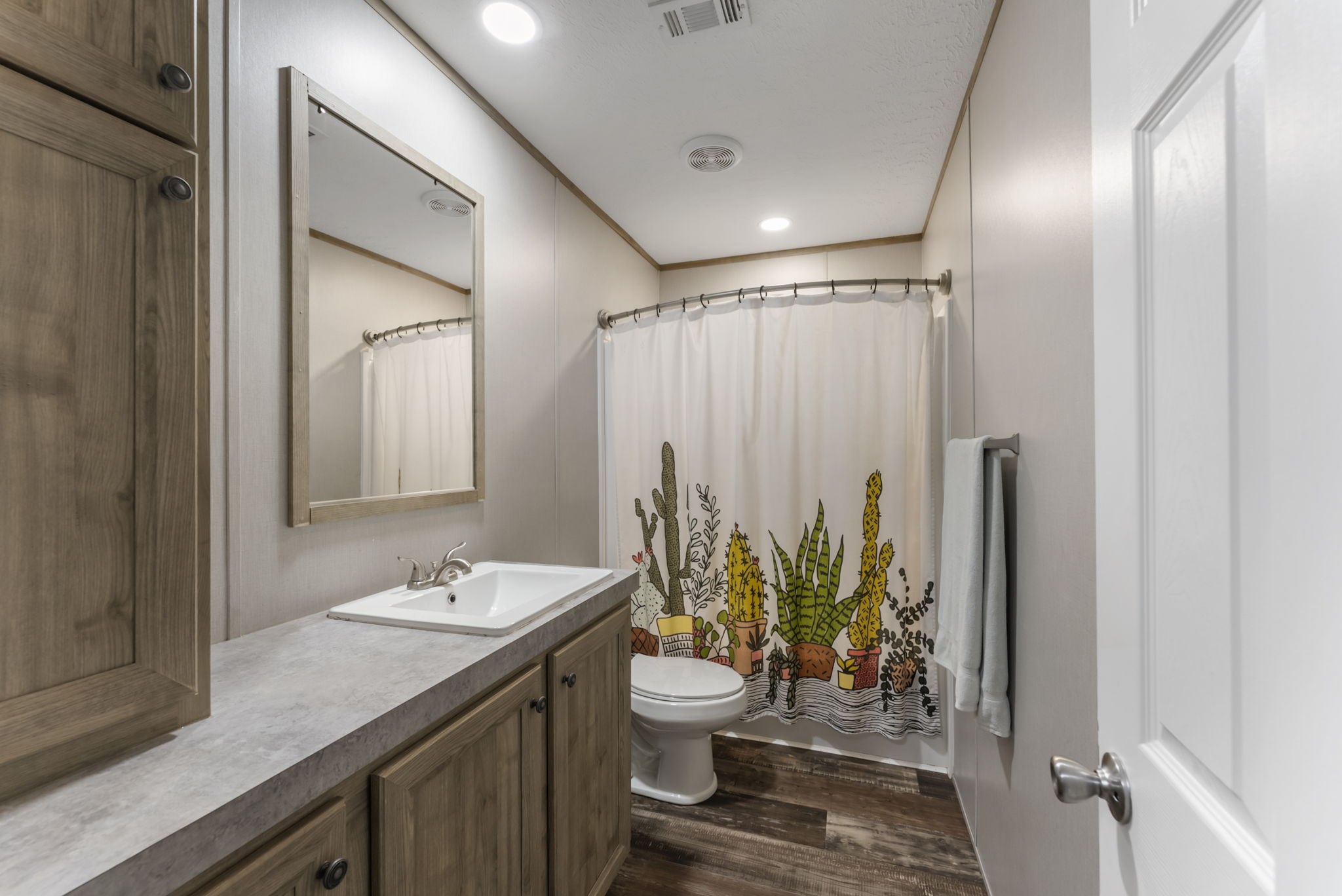 6913 Fm 3081 Road Willis, TX 77378 - Photo 20 of 46 a bathroom with a granite countertop sink a toilet and a mirror