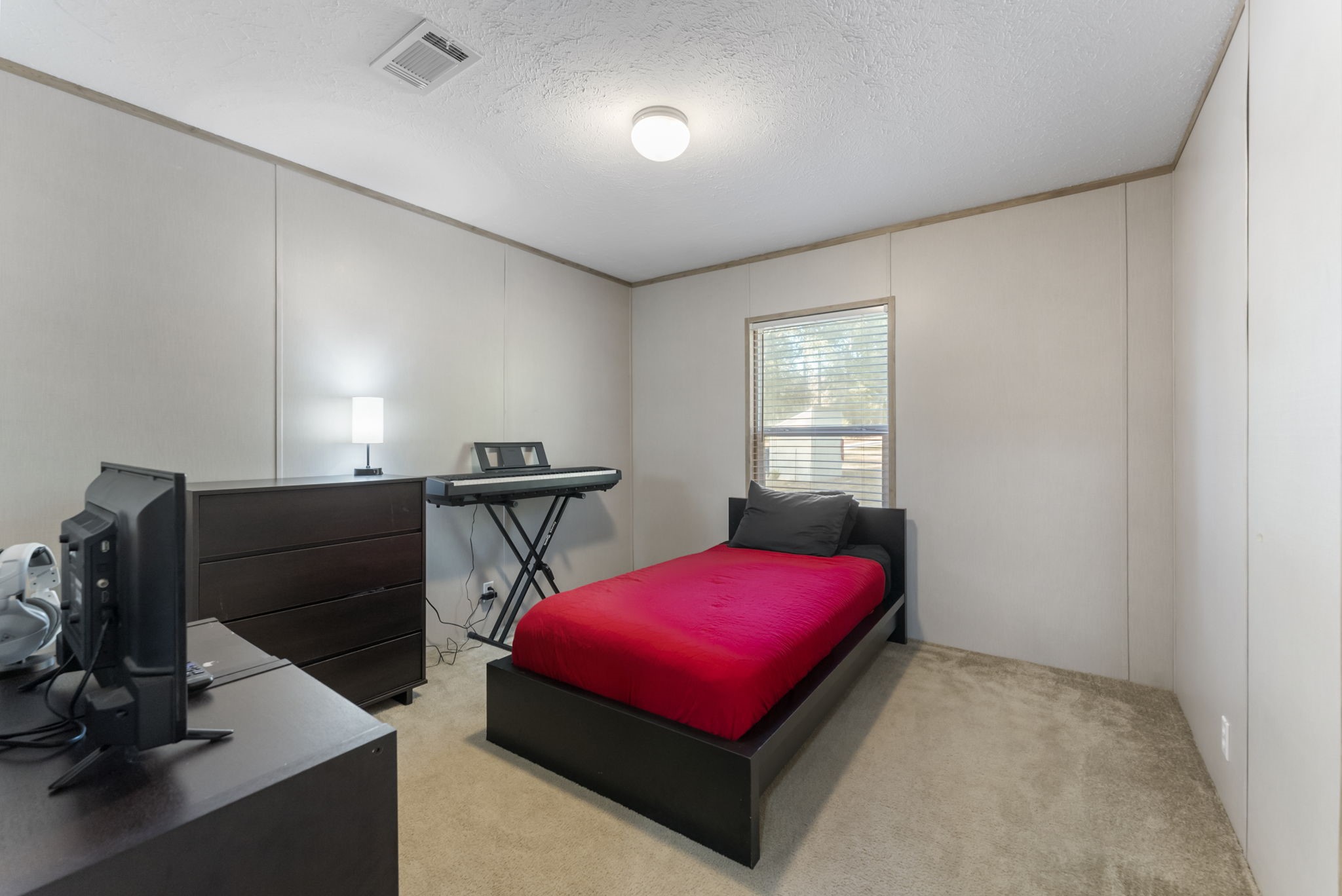 6913 Fm 3081 Road Willis, TX 77378 - Photo 21 of 46 a bedroom with furniture and a window