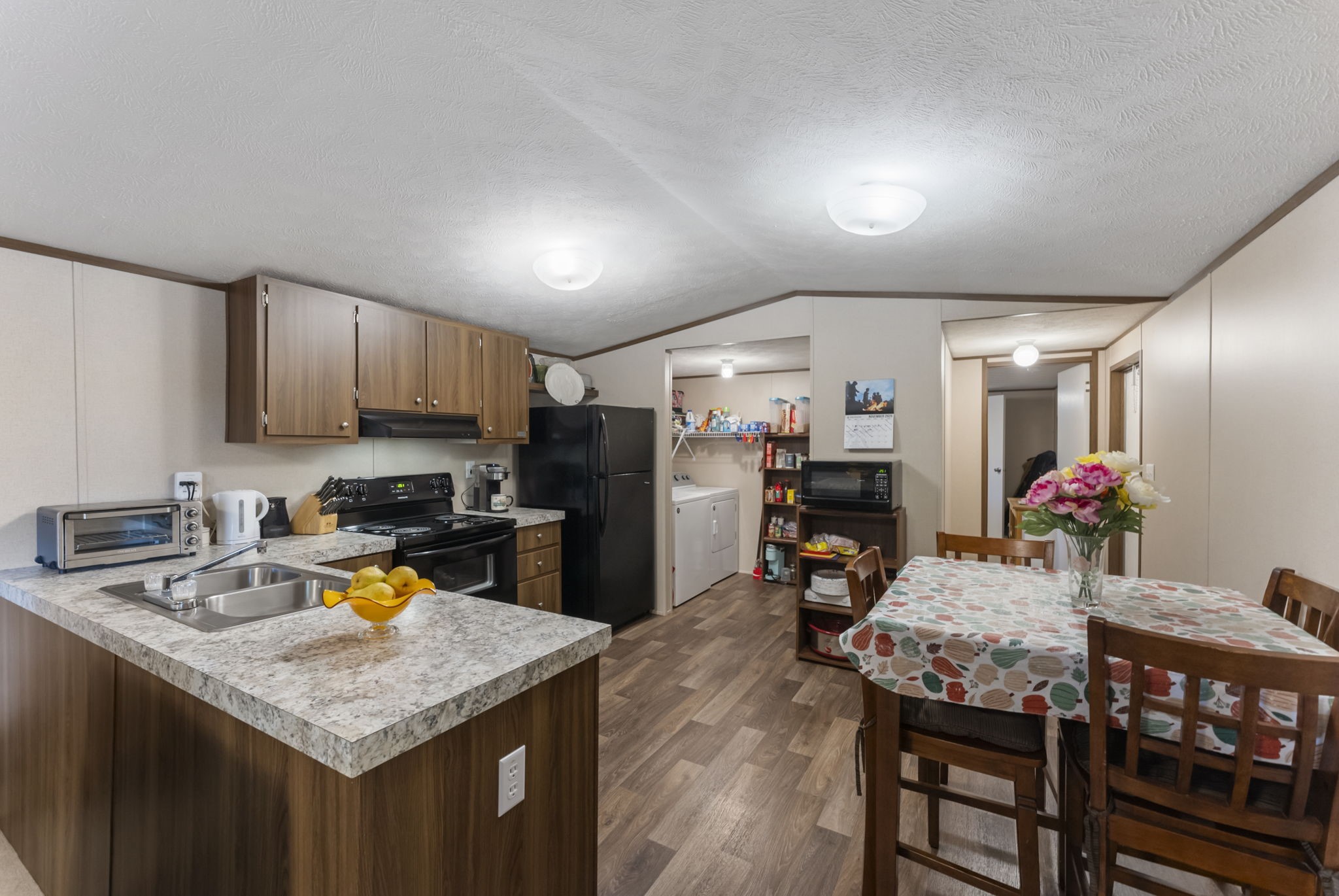 6913 Fm 3081 Road Willis, TX 77378 - Photo 34 of 46 a kitchen that has a table chairs in it and wooden floors