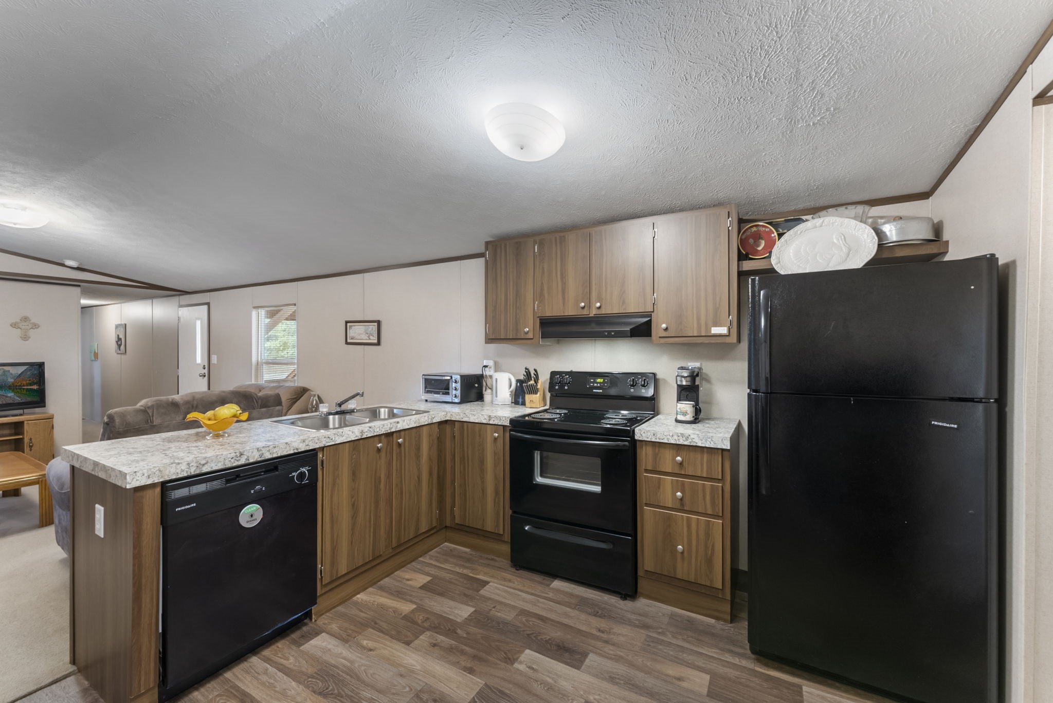 6913 Fm 3081 Road Willis, TX 77378 - Photo 35 of 46 a kitchen with stainless steel appliances granite countertop a refrigerator stove and sink