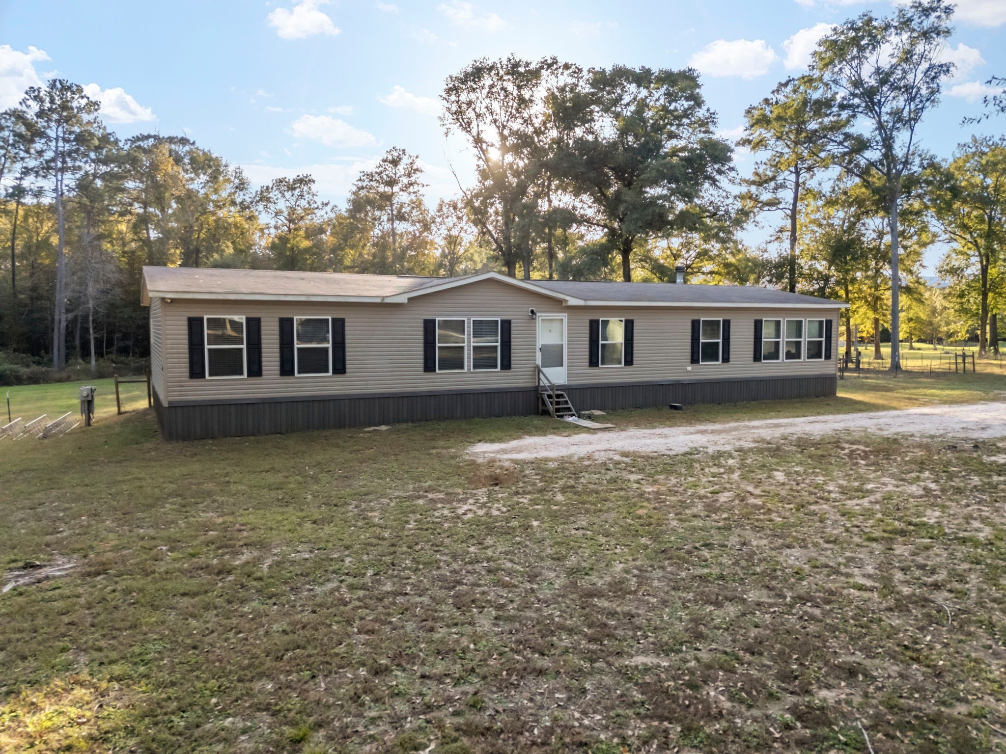 6913 Fm 3081 Road Willis, TX 77378 - Photo 4 of 46 a front view of a house with yard garden and trees