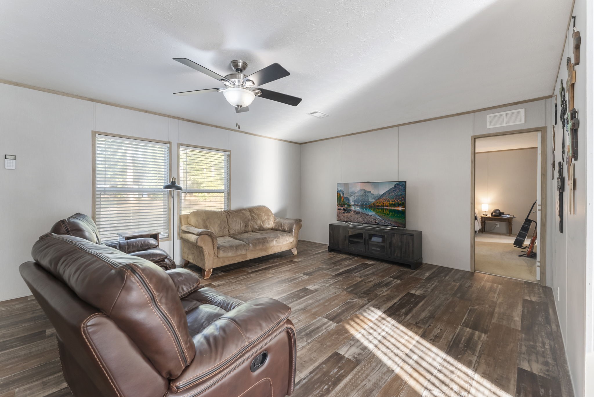 6913 Fm 3081 Road Willis, TX 77378 - Photo 8 of 46 a living room with furniture and a flat screen tv