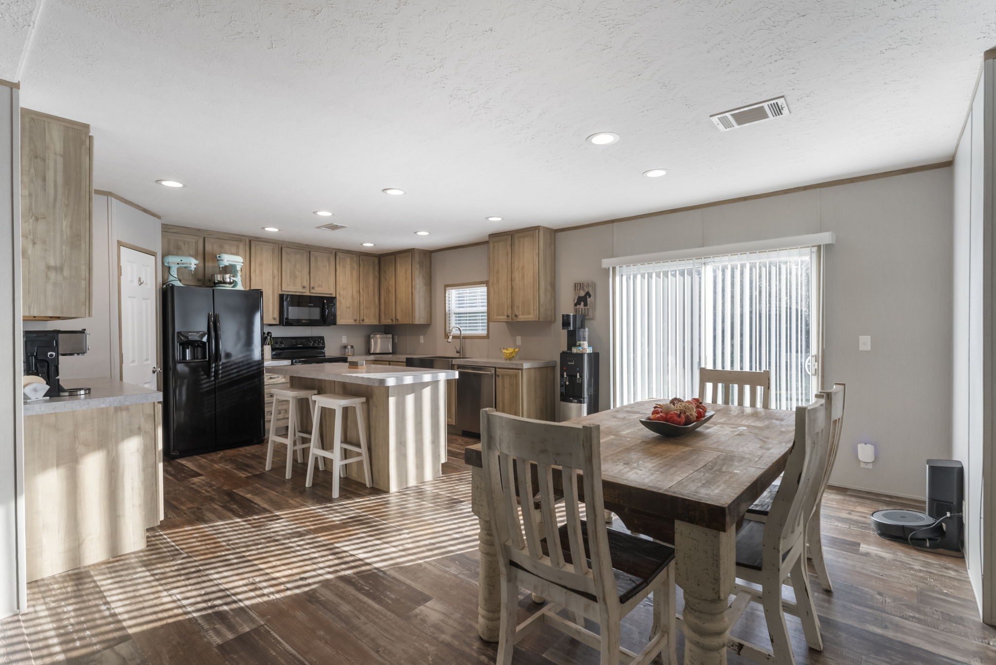 6913 Fm 3081 Road Willis, TX 77378 - Photo 10 of 46 a kitchen with refrigerator a sink and chairs