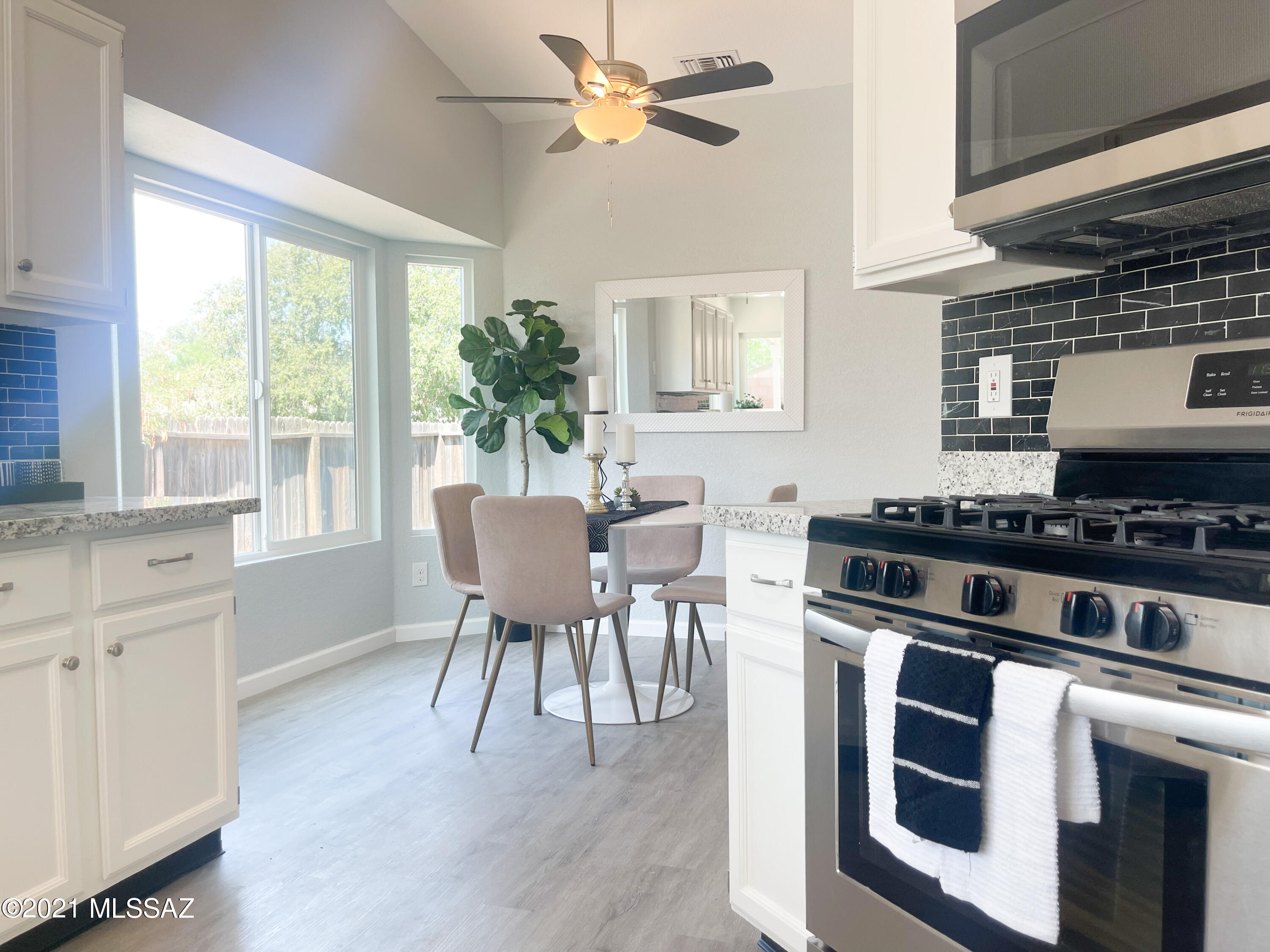 2611 West Sunset Road Tucson, AZ 85741 - Photo 9 of 20 a kitchen with a stove a sink and cabinets