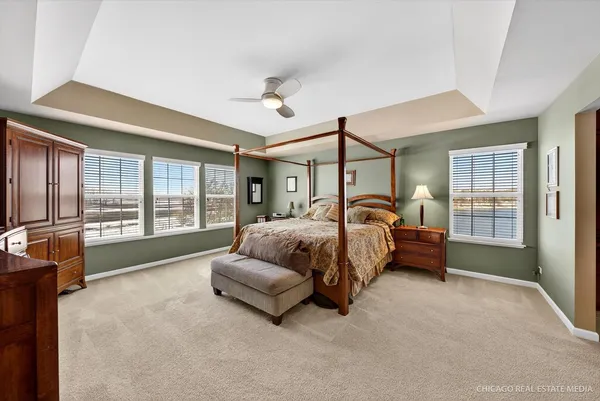 a spacious bedroom with a bed and a large window