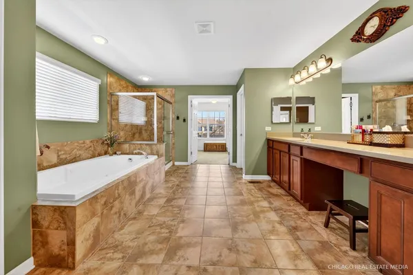 a large bathroom with a large tub and sink