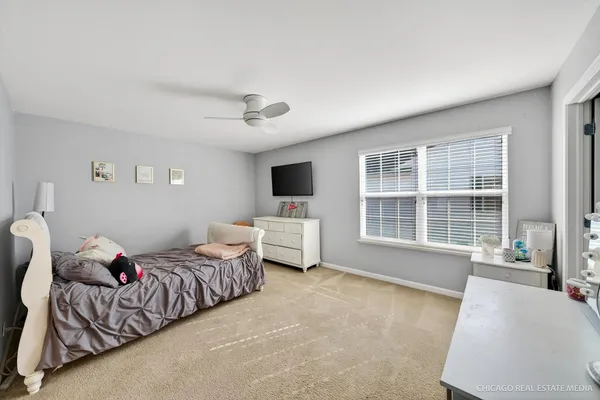 a bedroom with furniture and a flat screen tv