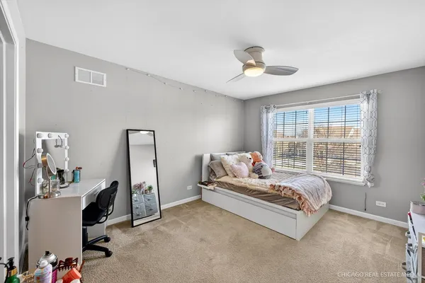 a bedroom with bed and a large window